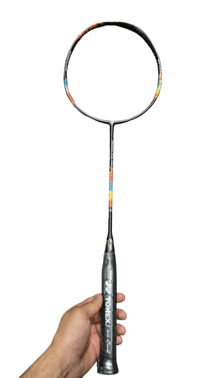 Close-up of unstrung isometric badminton racket head frame showing grommet channels